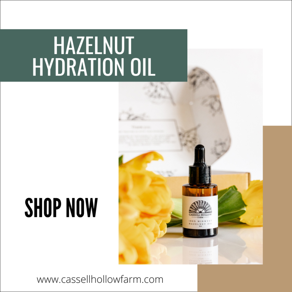 Promotional image of Cassell Hollow Farm's Hazelnut Hydration Oil bottle with yellow flowers and a 'Shop Now' call to action.